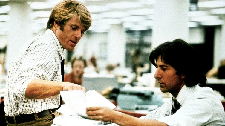 Robert Redford and Dustin Hoffman as Woodward and Bernstein collaborating at the Washington Post in All the President's Men (1976).