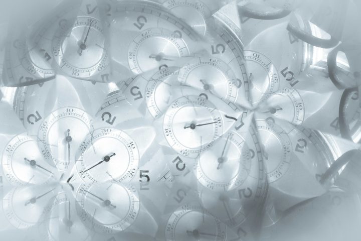 A kaleidoscopic image with clock faces.