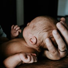 Person holding a baby.