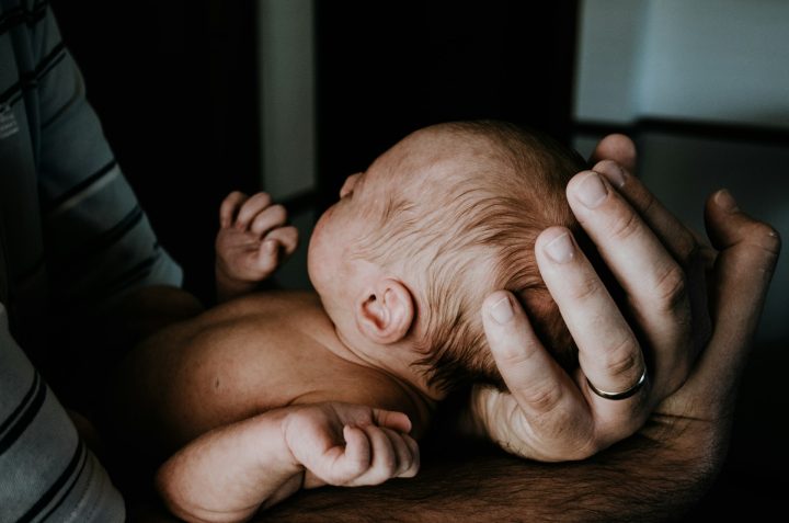 Person holding a baby.