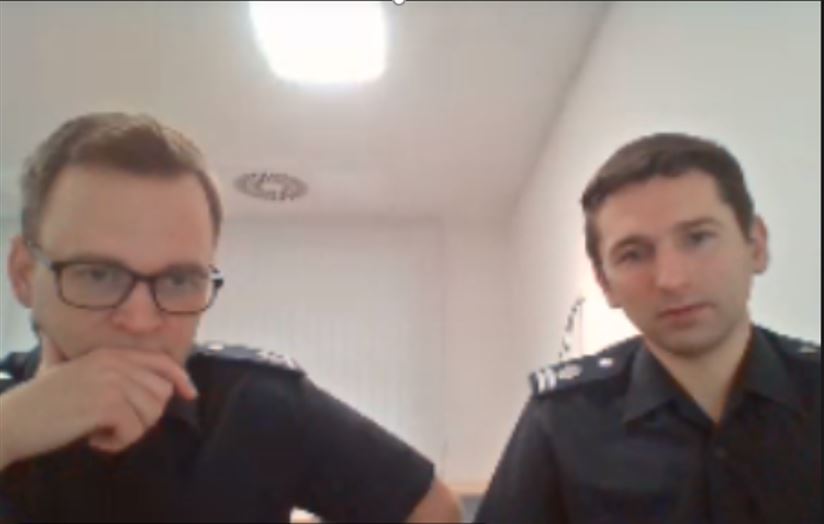 Two men looking at computer camera in an online meeting.