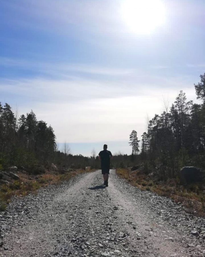 Student jogging in Finnish nature during summer.