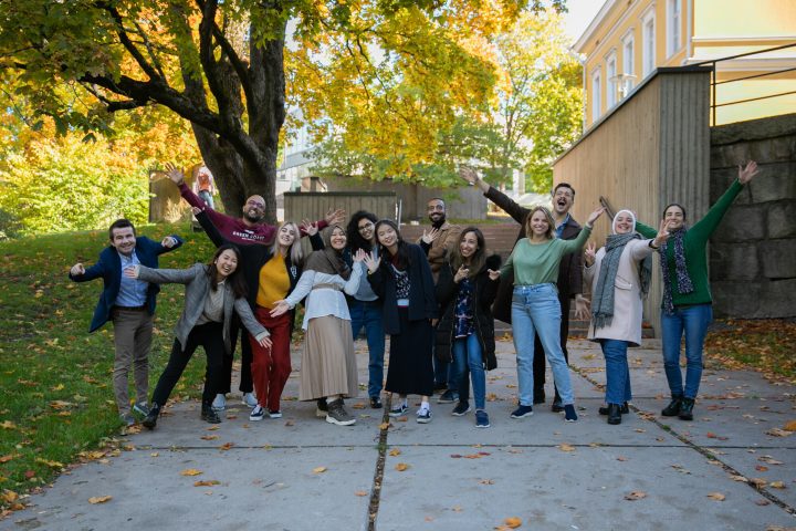Current international students of the University of Turku waive at campera on the University Hill.