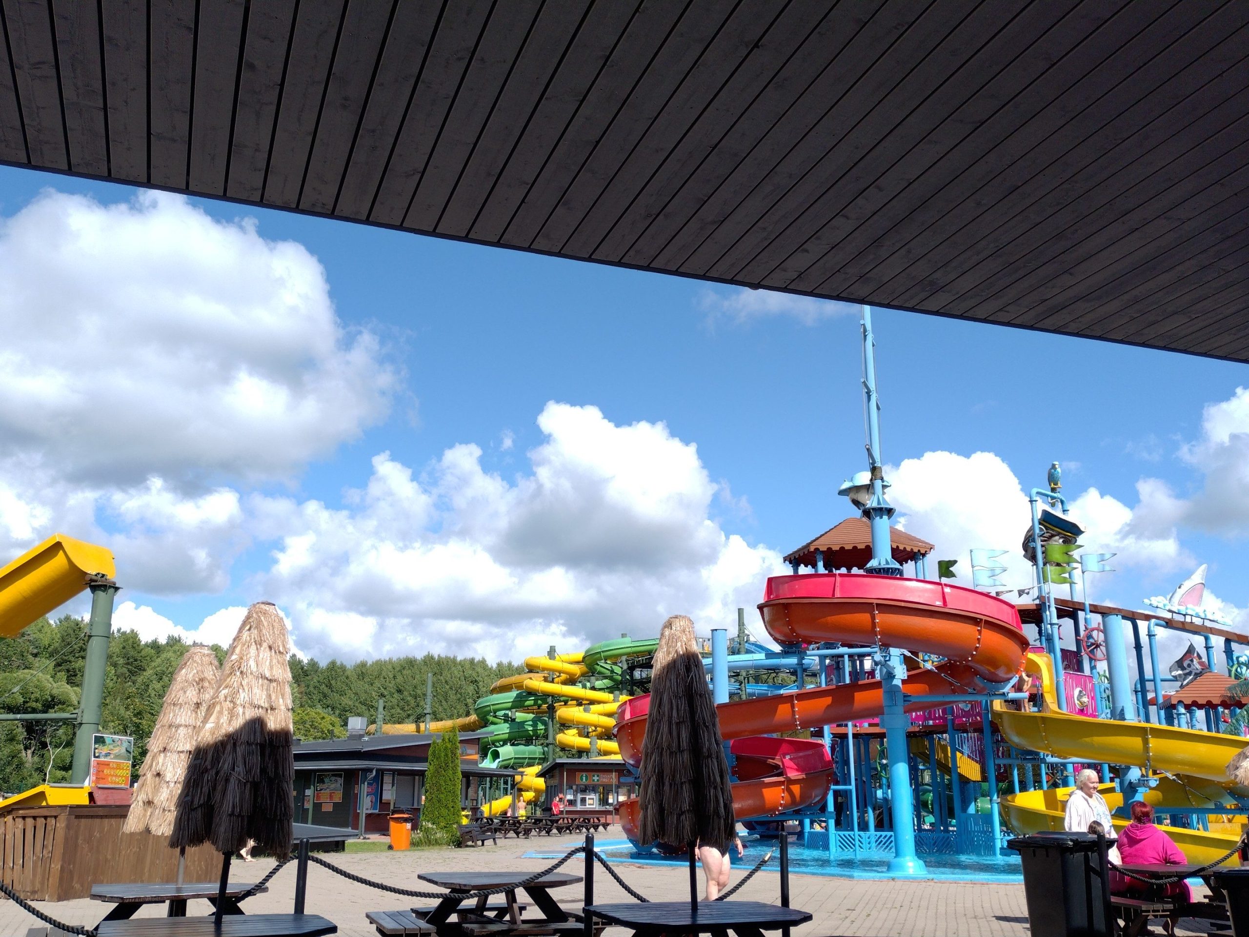 photo of various exciting water slides from the view of a restaurant in turku water park