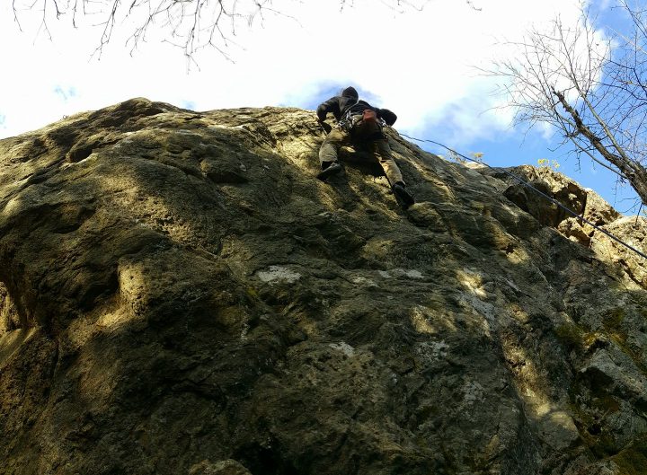 Exciting photo of an outdoor climber on a vertical rock in turku.
